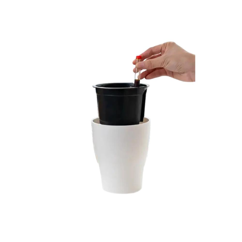 Hand showing how to insert inner pot with water indicator into a white self-watering flower planter – easy watering system